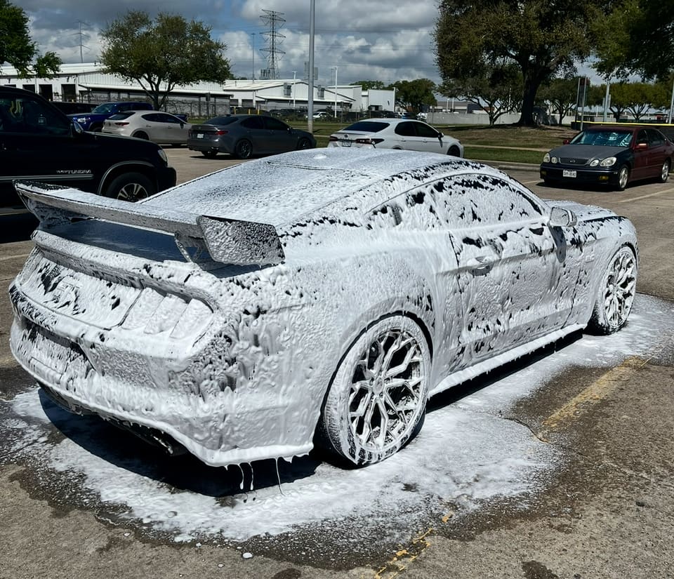 Dodge Charger covered in snow foam during the wash