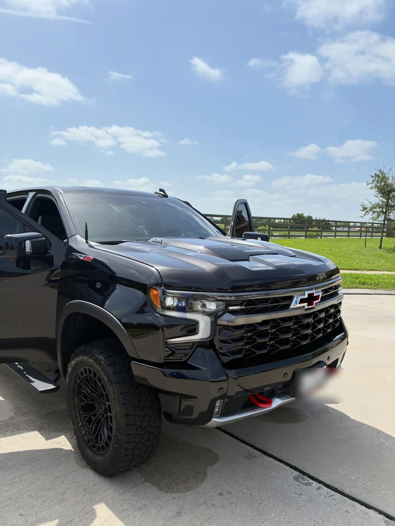 Black Chevrolet Silverado ZR2 detailed and parked on a driveway
