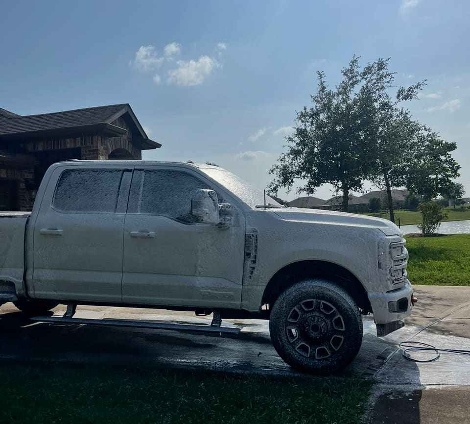 Ford Super Duty covered in snow foam during the wash